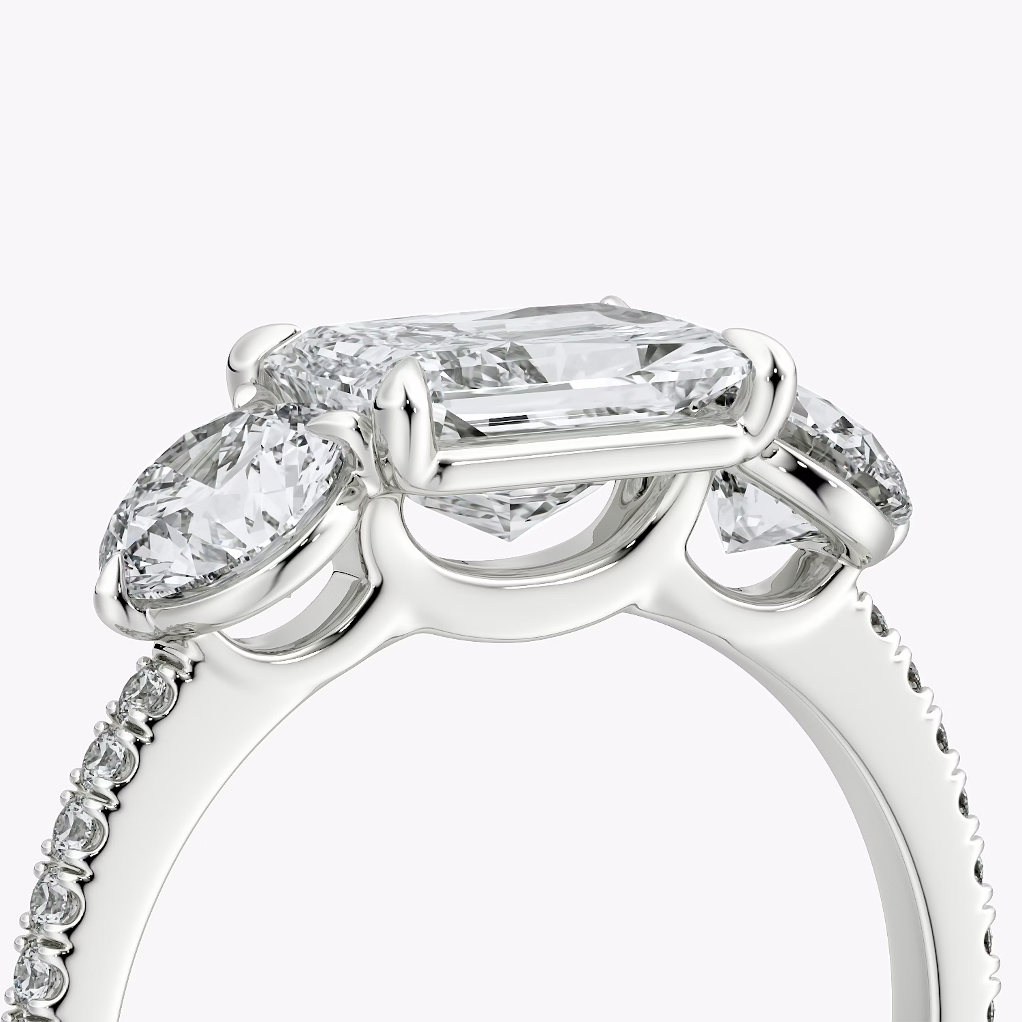 The Three Stone | Radiant | 18k | White Gold | bandAccent: Pavé | diamondOrientation: horizontal | sideStoneCarat: 0.50ct | sideStoneShape: Round Brilliant | caratWeight: other