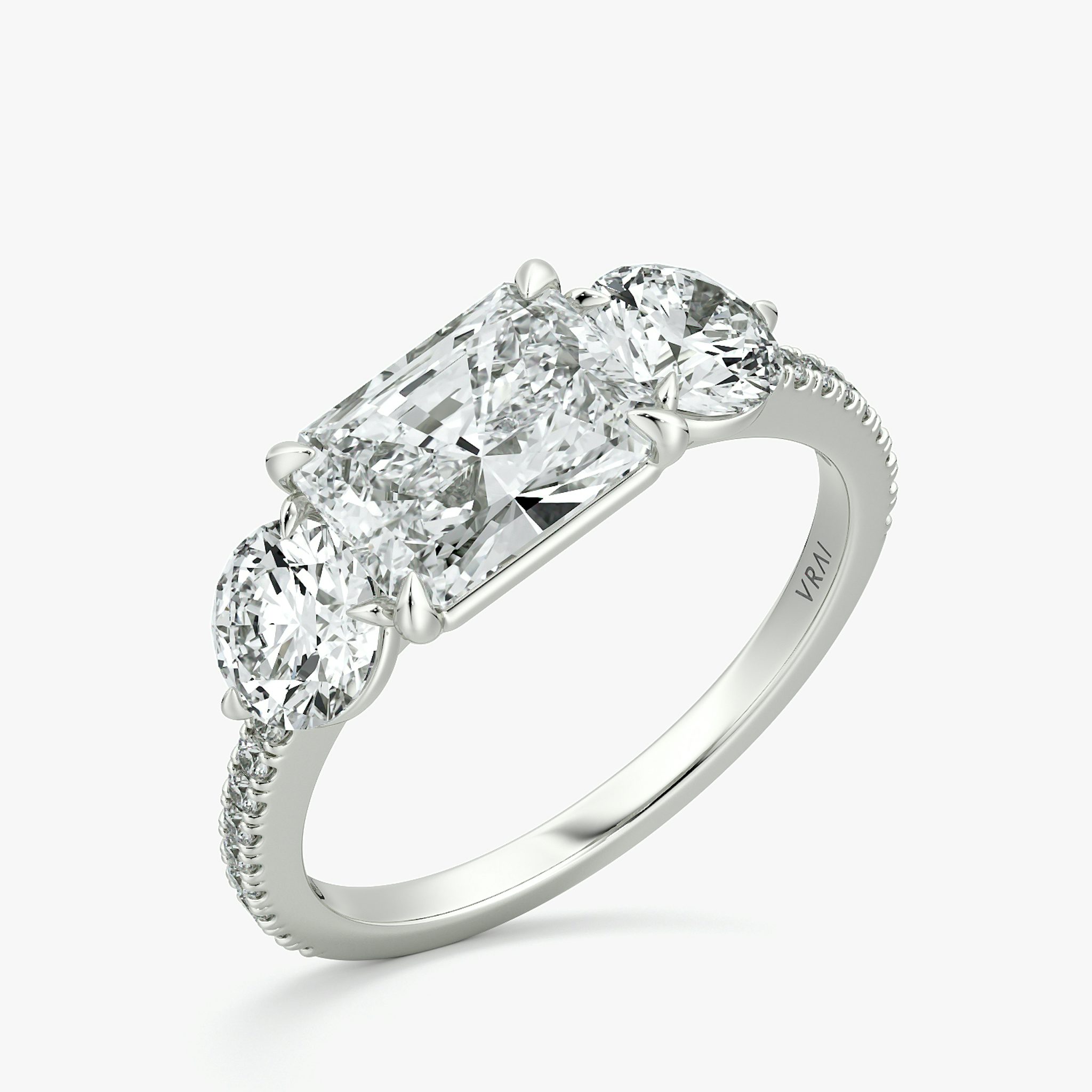 The Three Stone | Radiant | 18k | White Gold | bandAccent: Pavé | diamondOrientation: horizontal | sideStoneCarat: 0.50ct | sideStoneShape: Round Brilliant | caratWeight: other