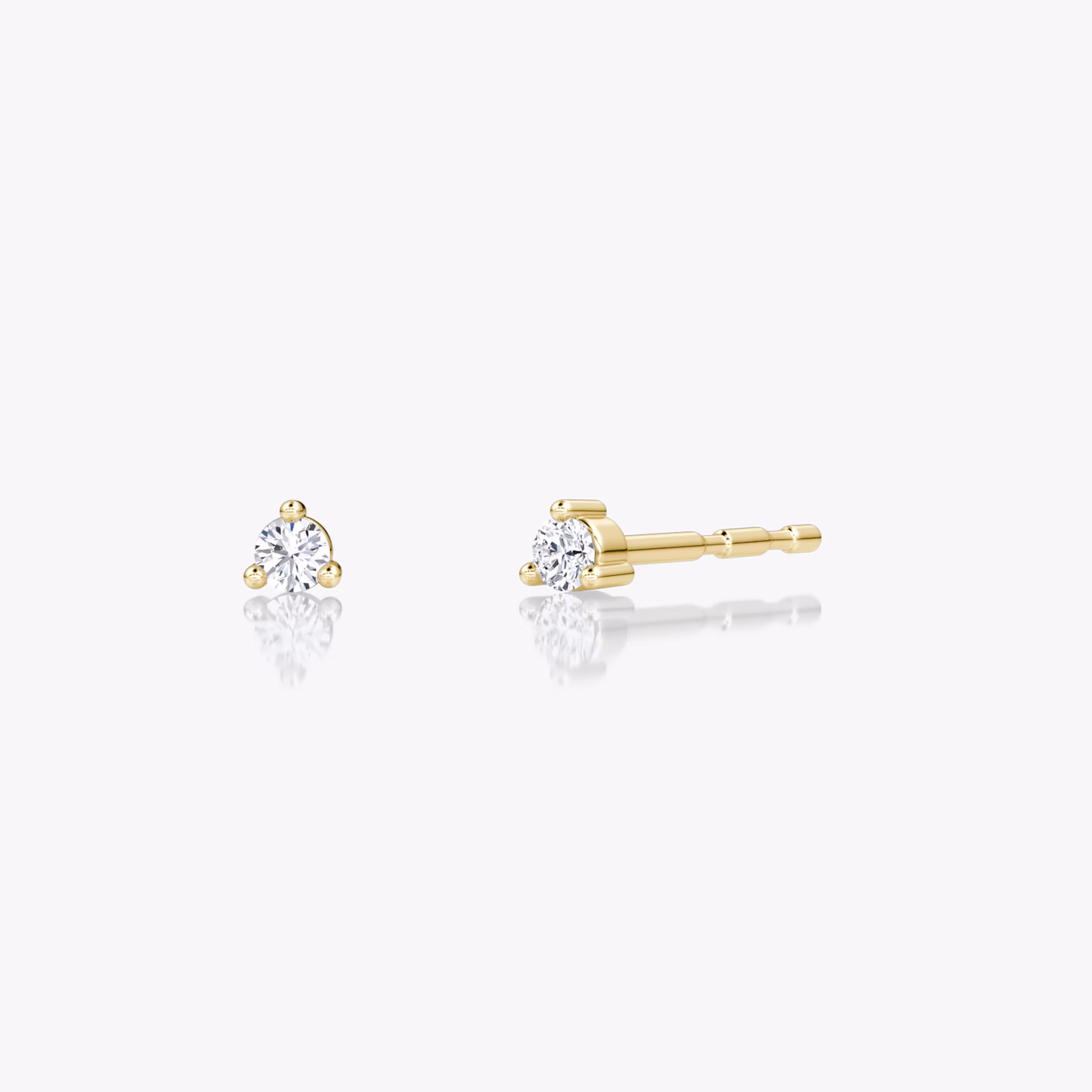 Tiny round brilliant diamond studs in 14k yellow gold, minimalist fine jewelry ideal for everyday wear.