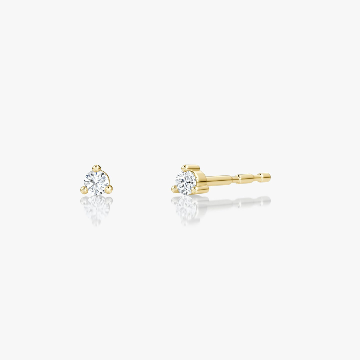 Tiny round brilliant diamond studs in 14k yellow gold, minimalist fine jewelry ideal for everyday wear.