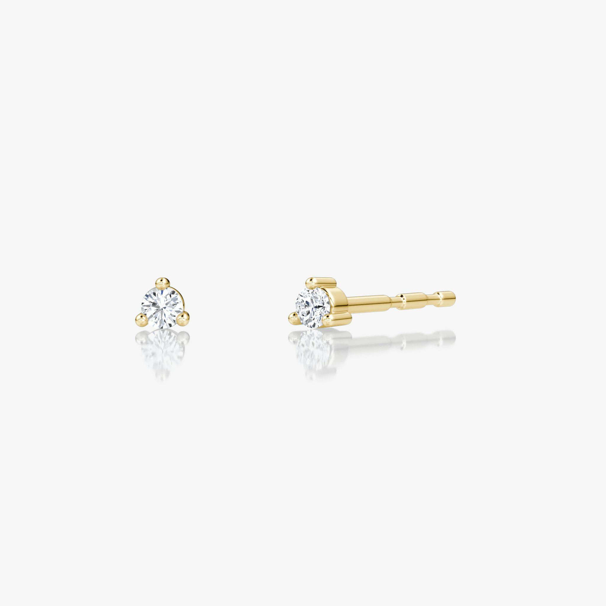 Tiny round brilliant diamond studs in 14k yellow gold, minimalist fine jewelry ideal for everyday wear.
