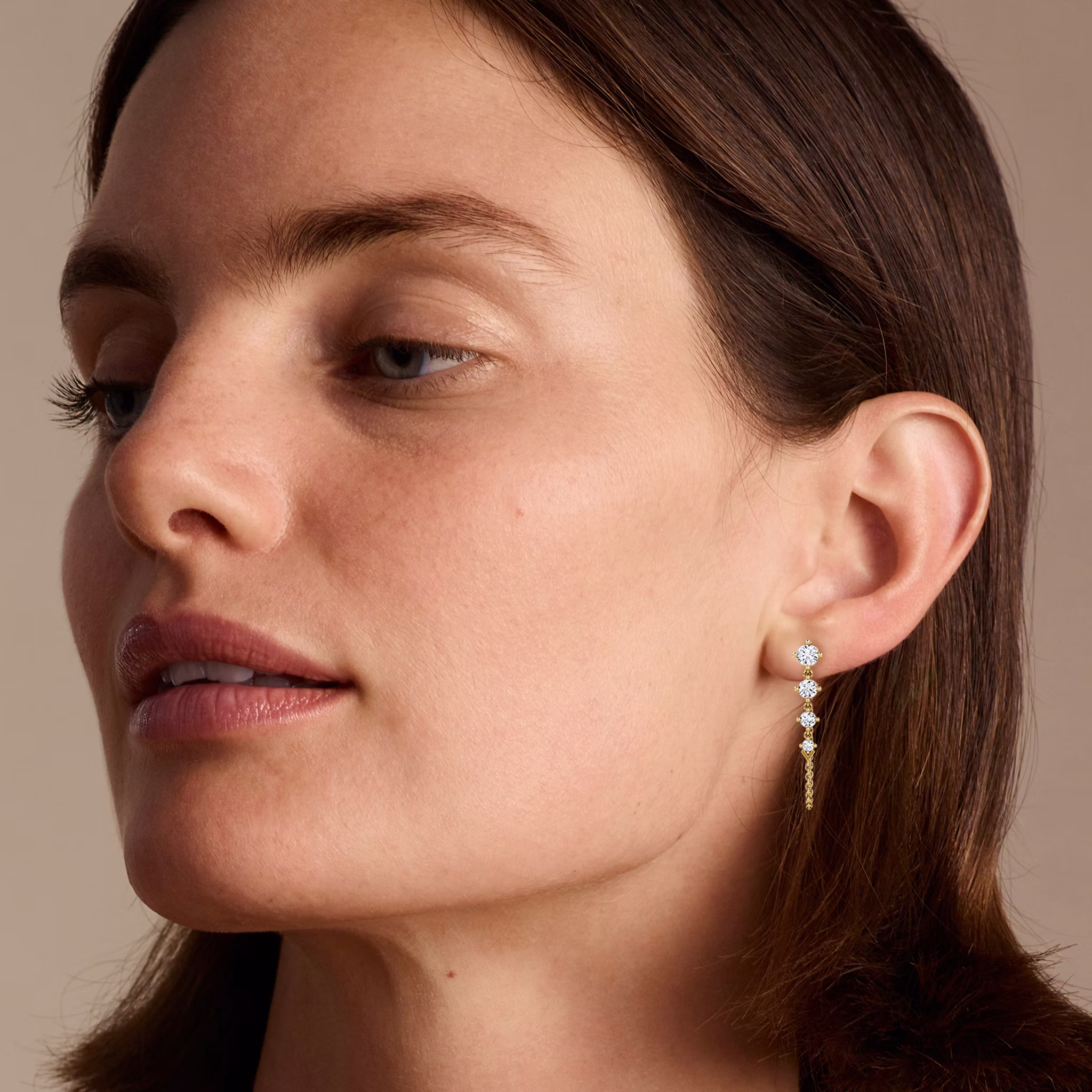 Model wearing a dangle diamond earring