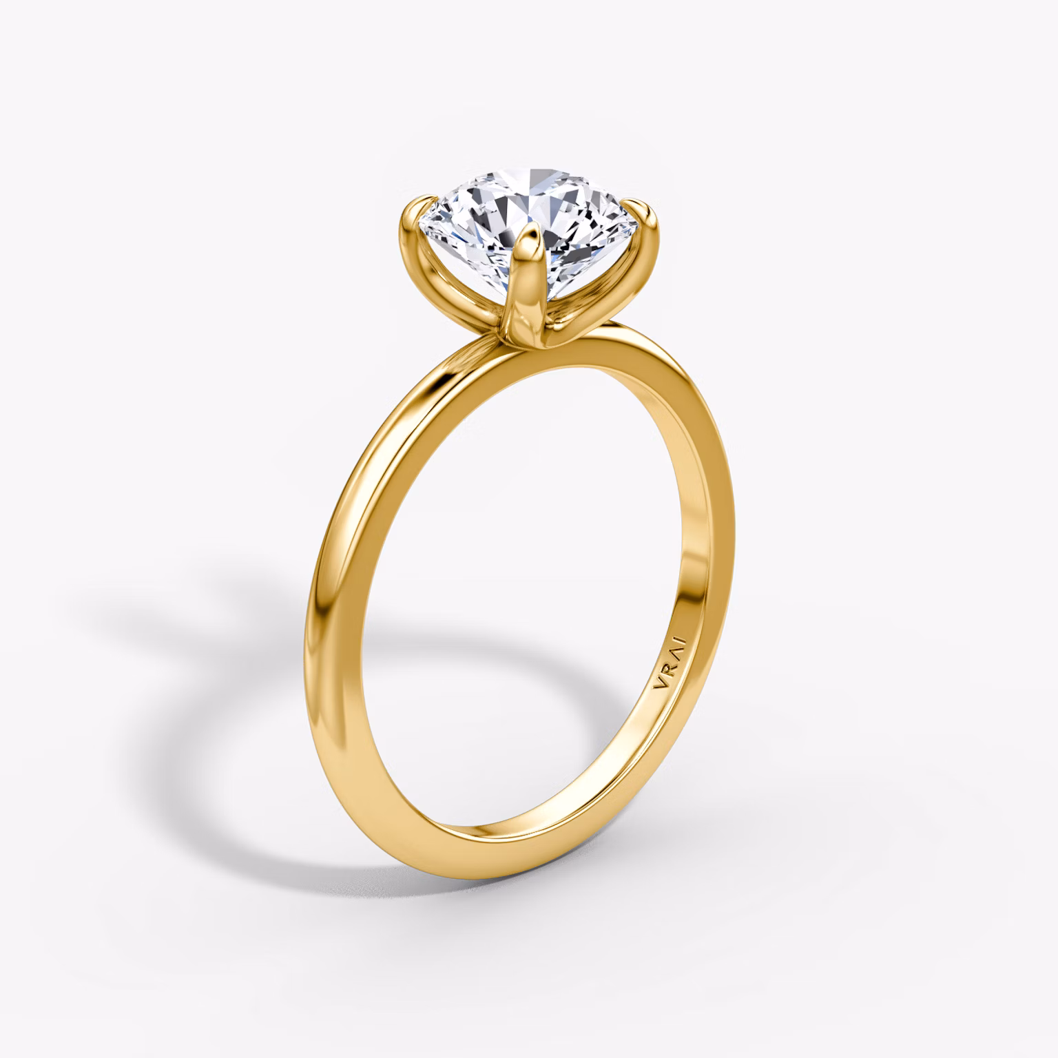 Solitaire engagement ring with round brilliant diamond on a plain band, highlighting timeless elegance and minimalist design.
