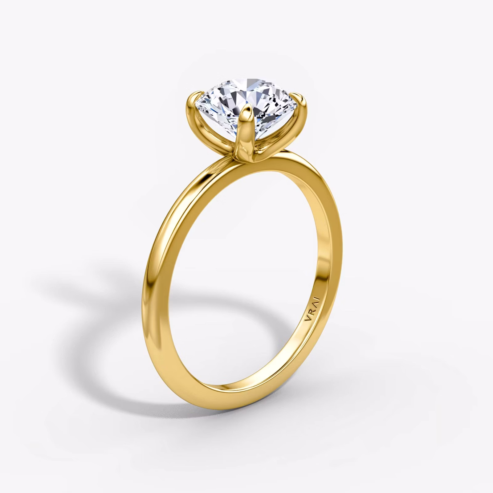 Solitaire engagement ring with round brilliant diamond on a plain band, highlighting timeless elegance and minimalist design.