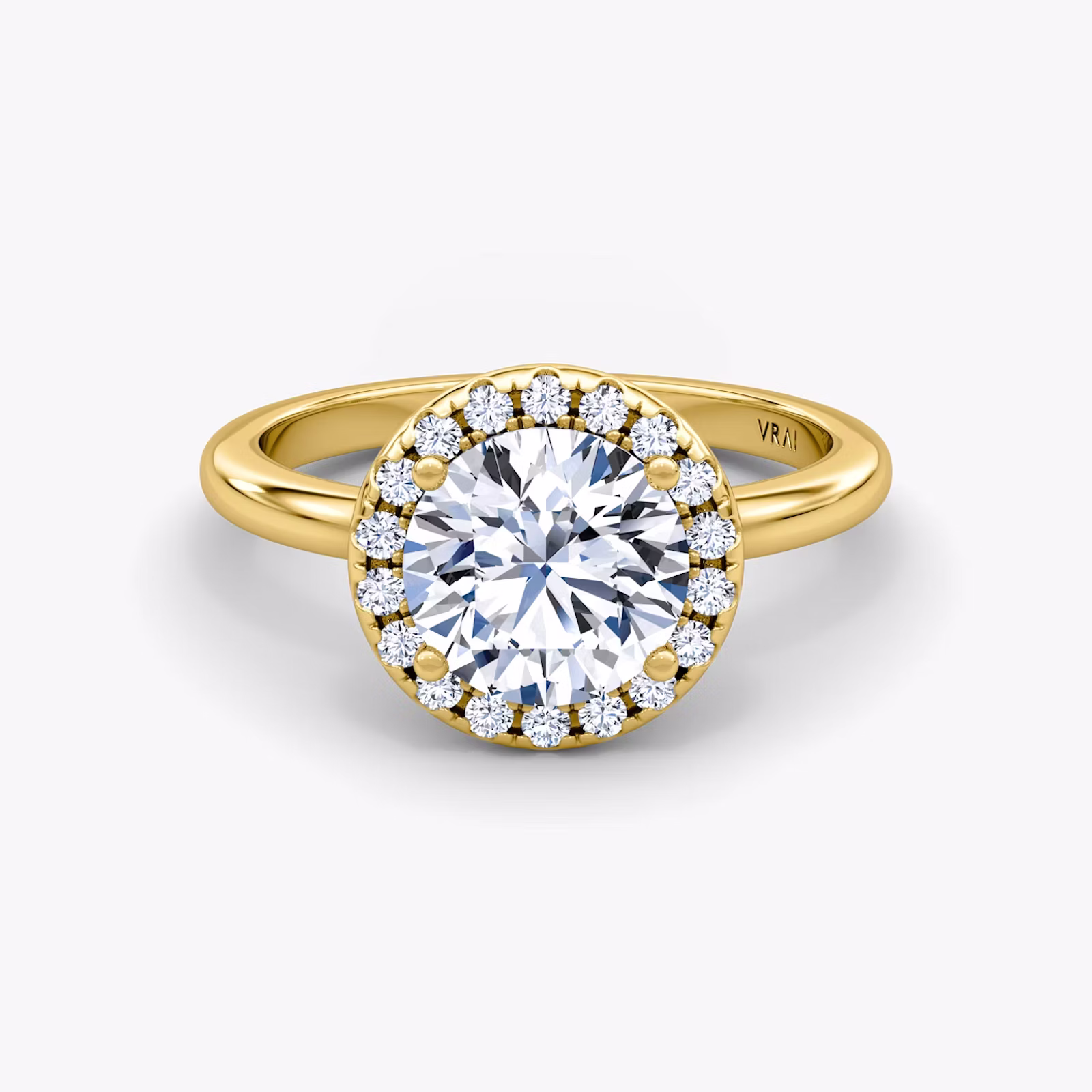 Halo engagement ring with a round center diamond encircled by pavé diamonds on a slim metal band, shown in front view.