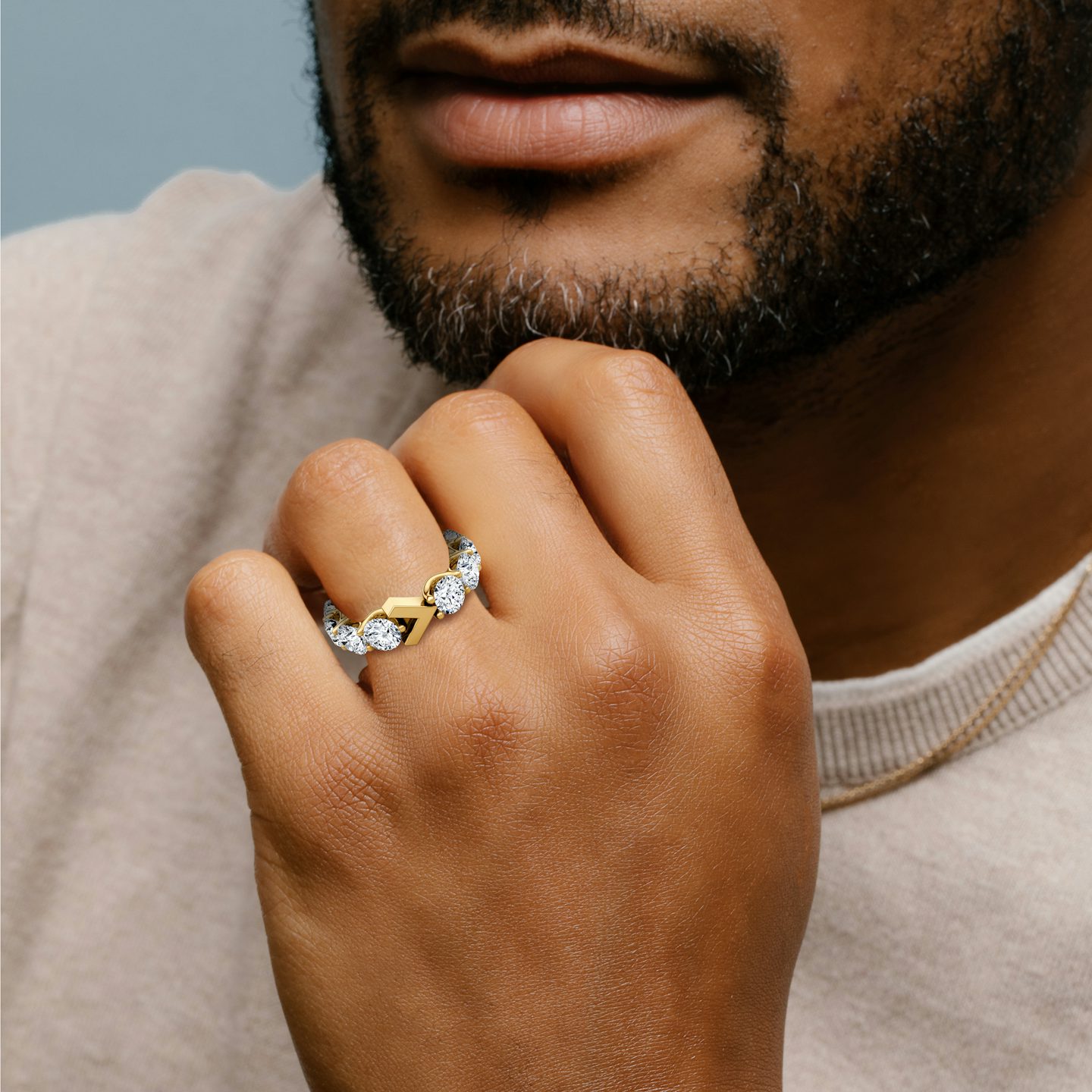 Man wearing a 6ctw yellow gold V Eternity Band