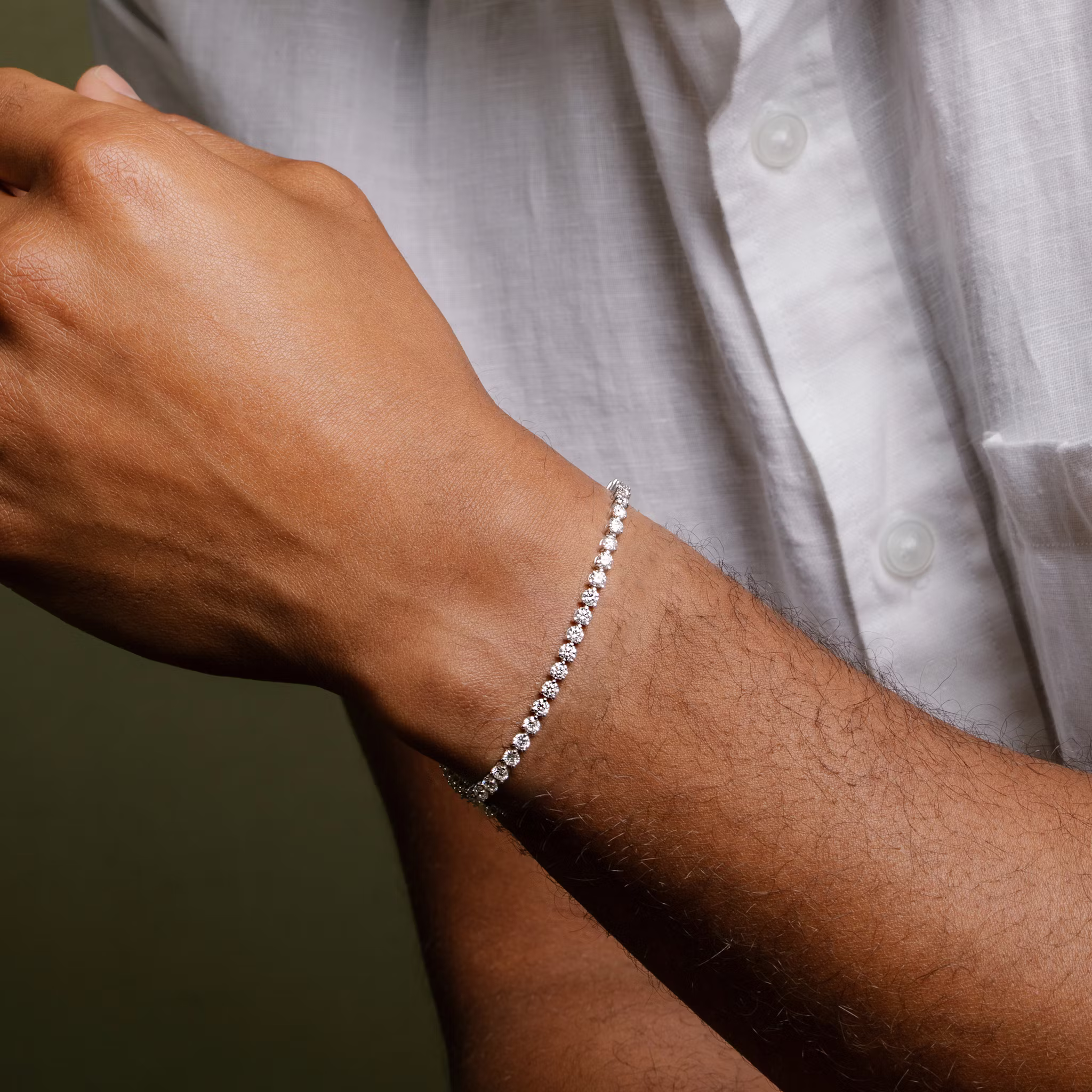 Male model wearing tennis bracelet on wrist