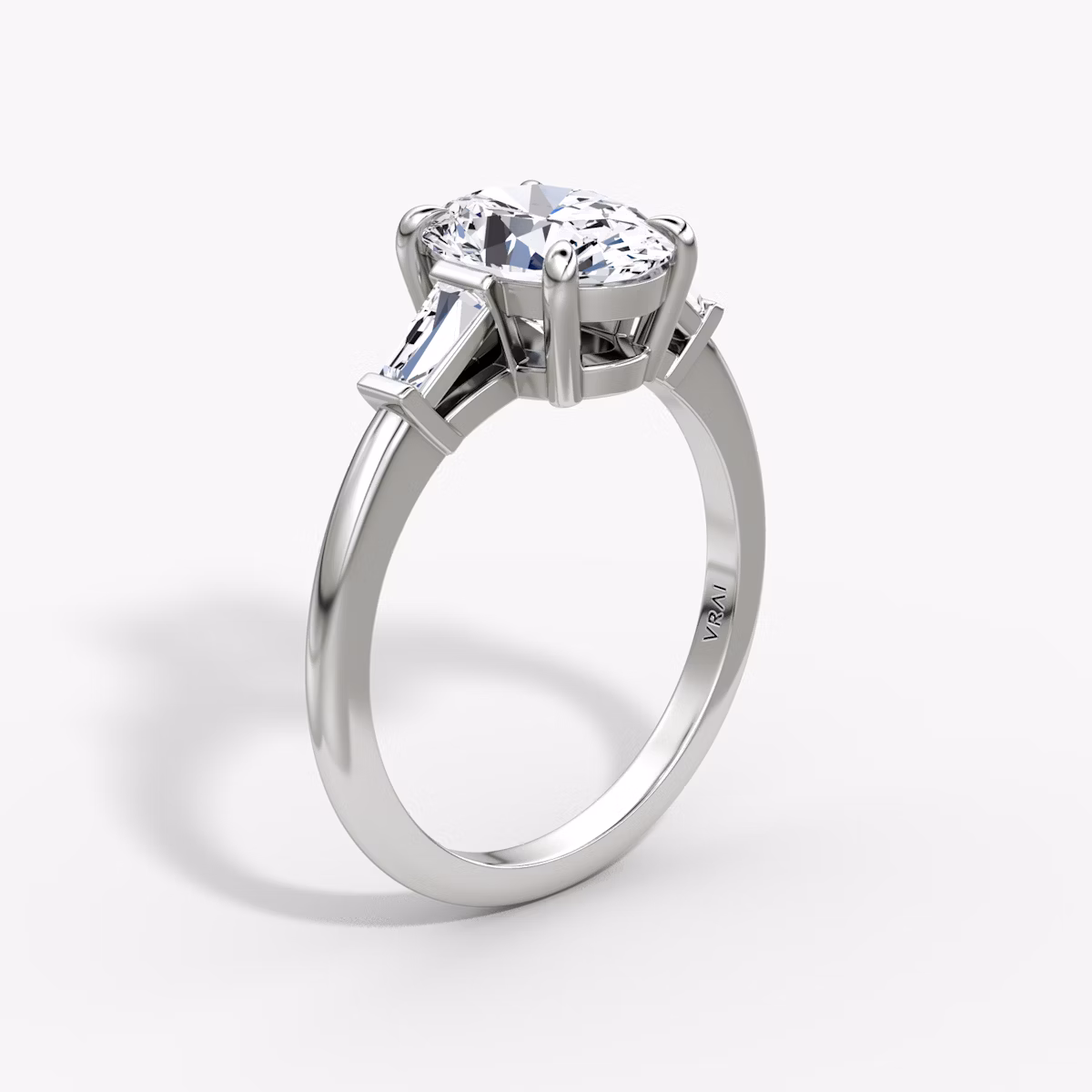 The Tapered Baguette Three Stone | Oval | 18k | White Gold | bandAccent: Plain | caratWeight: 1.0ct | excludeFromFeed: null | diamondOrientation: vertical