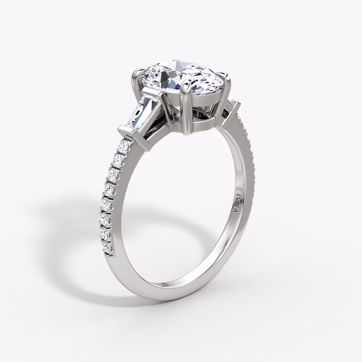 The Tapered Baguette Three Stone | Oval | Platinum | bandAccent: Pavé | caratWeight: 1.0ct | excludeFromFeed: null | diamondOrientation: vertical