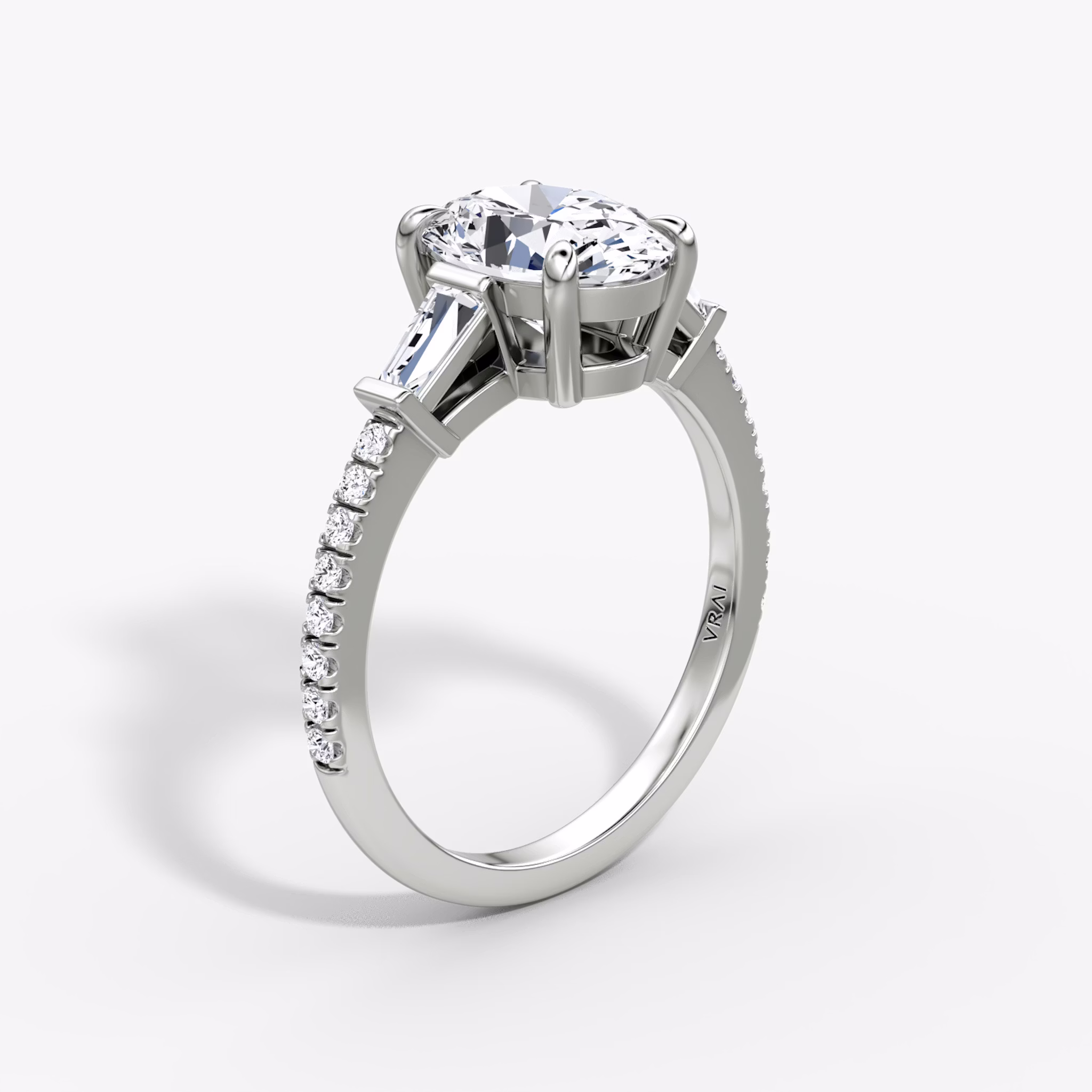 The Tapered Baguette Three Stone | Oval | 18k | White Gold | bandAccent: Pavé | excludeFromFeed: null | diamondOrientation: vertical | caratWeight: other