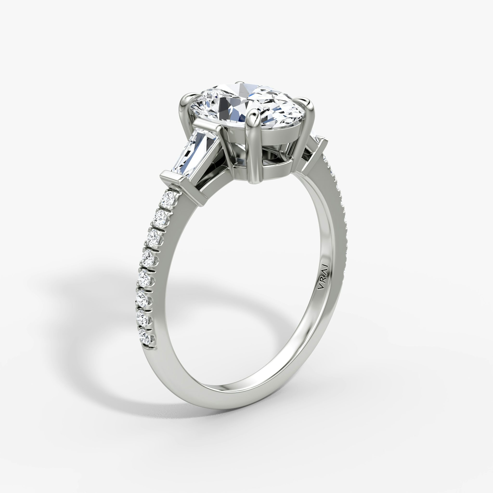 The Tapered Baguette Three Stone | Oval | 18k | White Gold | bandAccent: Pavé | excludeFromFeed: null | diamondOrientation: vertical | caratWeight: other