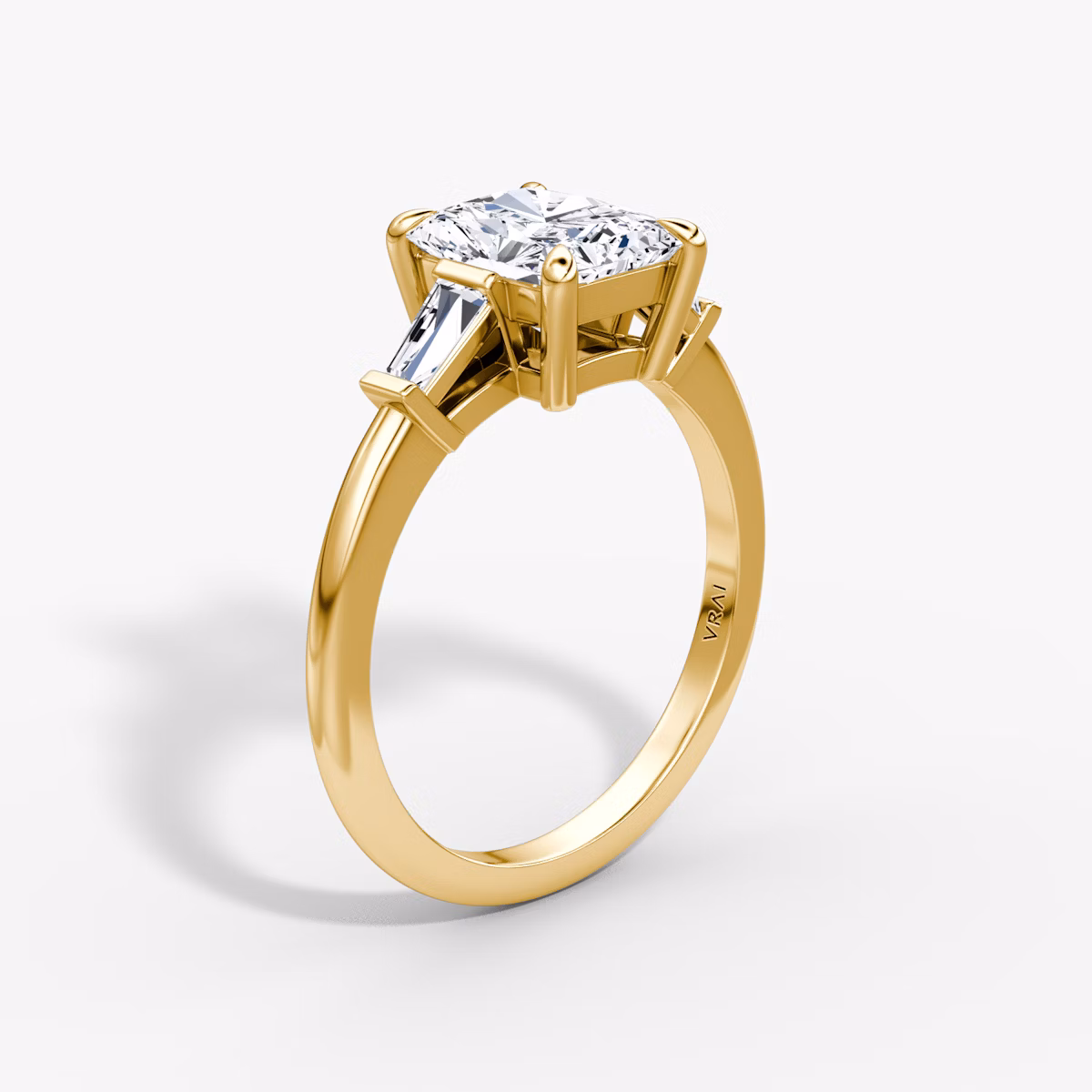 The Tapered Baguette Three Stone | Radiant | 18k | Yellow Gold | bandAccent: Plain | caratWeight: 1.0ct | excludeFromFeed: null | diamondOrientation: vertical