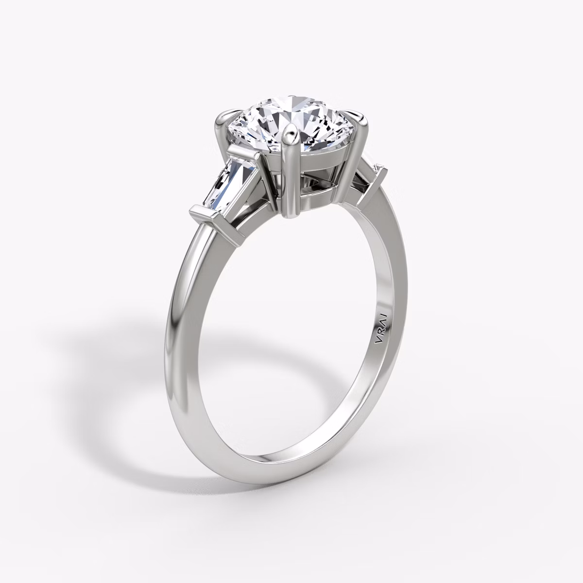 The Tapered Baguette Three Stone | Round Brilliant | Platinum | bandAccent: Plain | caratWeight: other | excludeFromFeed: null | diamondOrientation: vertical