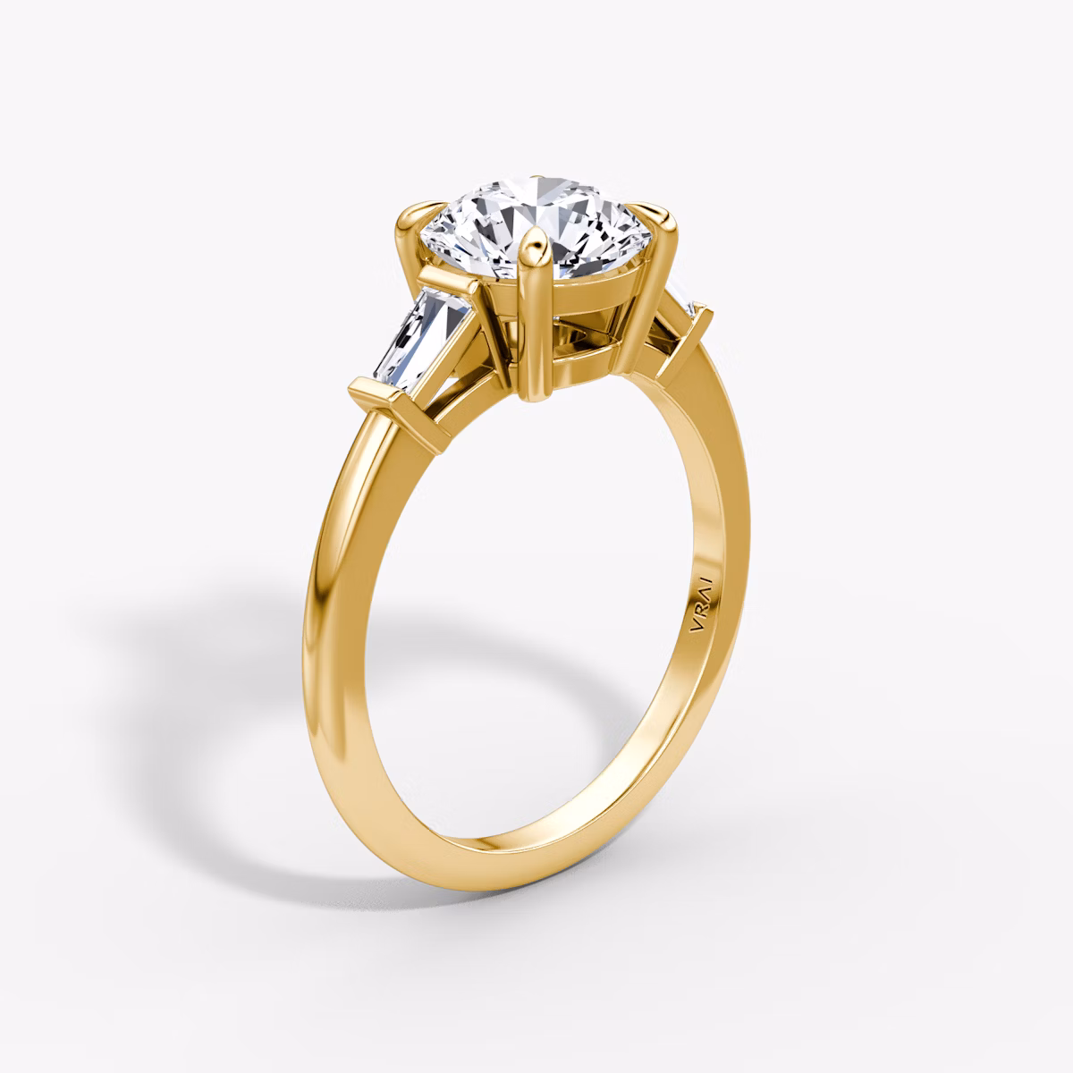 The Tapered Baguette Three Stone | Round Brilliant | 18k | Yellow Gold | bandAccent: Plain | caratWeight: other | excludeFromFeed: null | diamondOrientation: vertical
