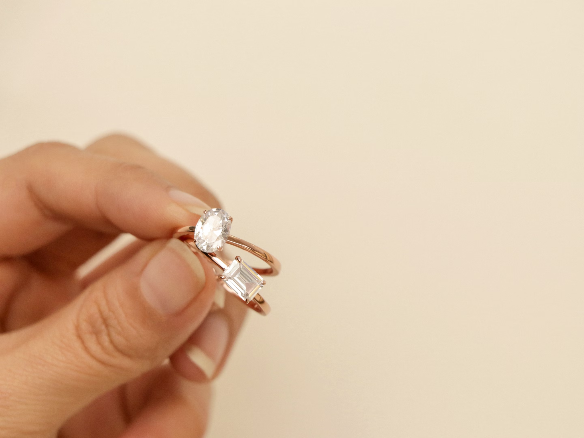 A hand is holding a diamond ring.